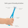 Frida Baby Training Toothbrush | Toddler Toothbrush for 18-24 Months, Easy-Grip Handle, Triple Angle Bristles, Soft Toothbrush Bristles, Stay-Put Suction Cup | Blue